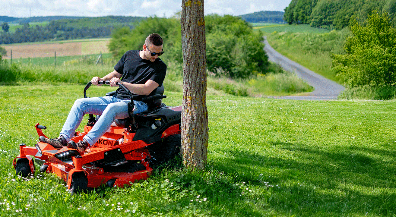 Ariens Zero-Turn driving around a tree, showcasing the steering with a Zero-Turn mower