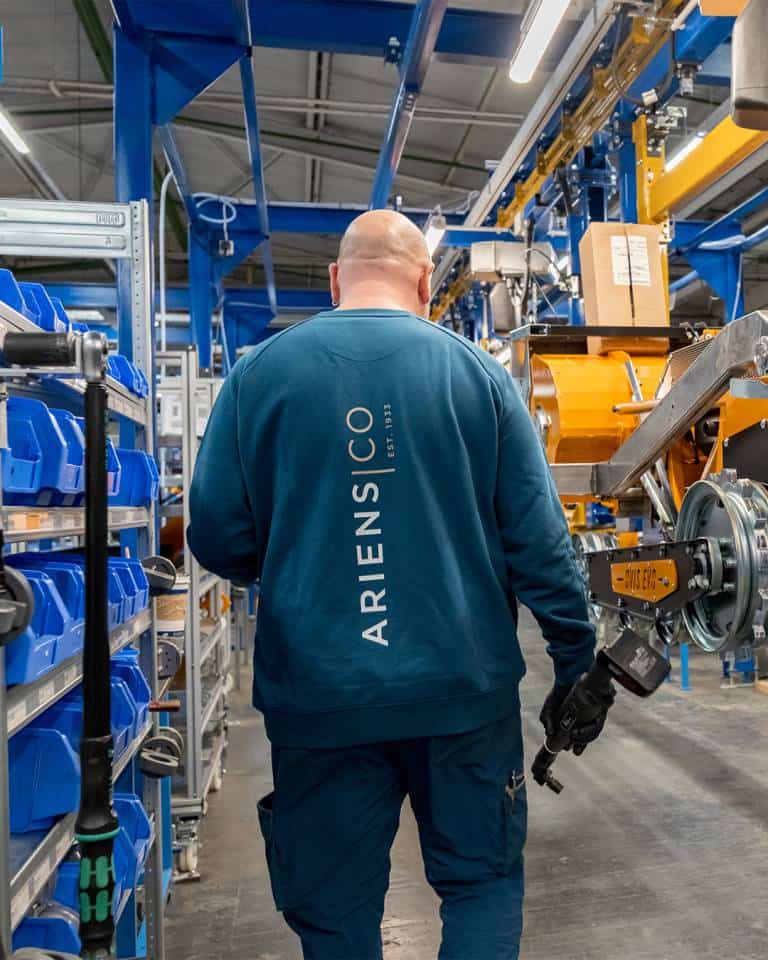 Factory worker of AriensCo EMEAA wearing their new turquise work wear inside their factory in Bühlertann, Germany