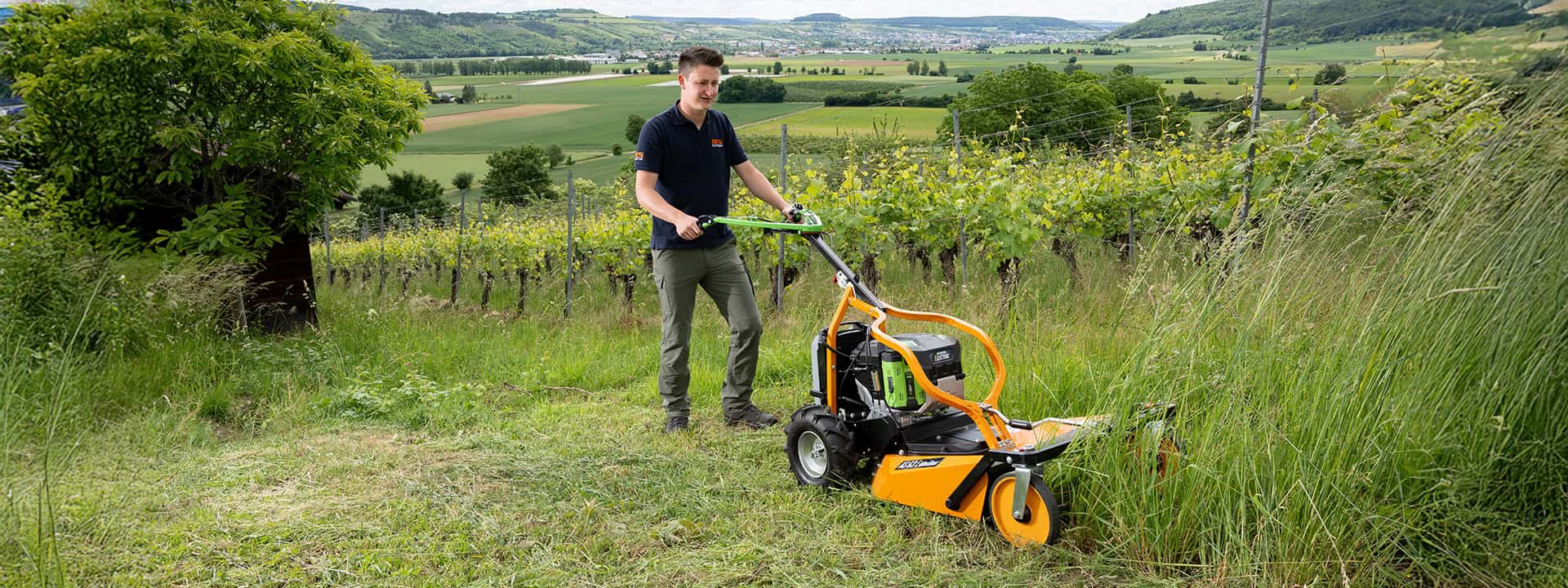 Man using an AS-Motor flail mower, AS 63 E-Allmäher, mowing high gras on steep slopes