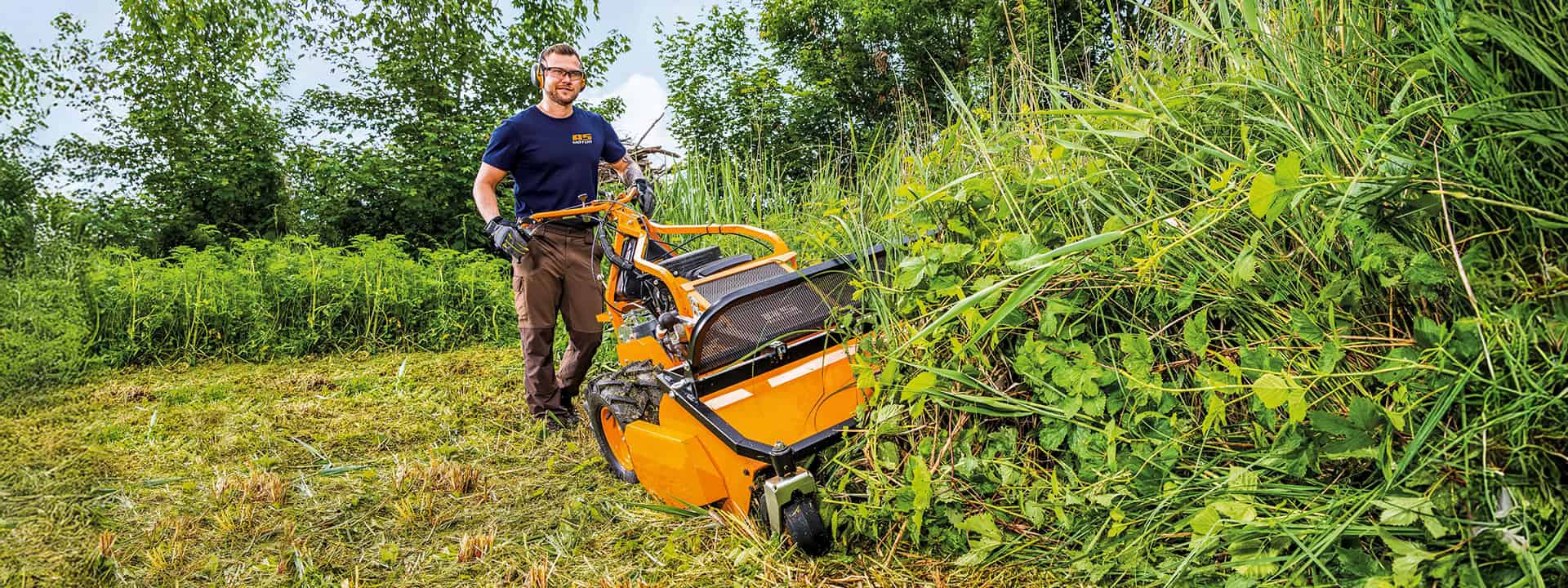 Man using an AS-Motor flail mower, AS 901 SM, mowing high gras on steep slopes