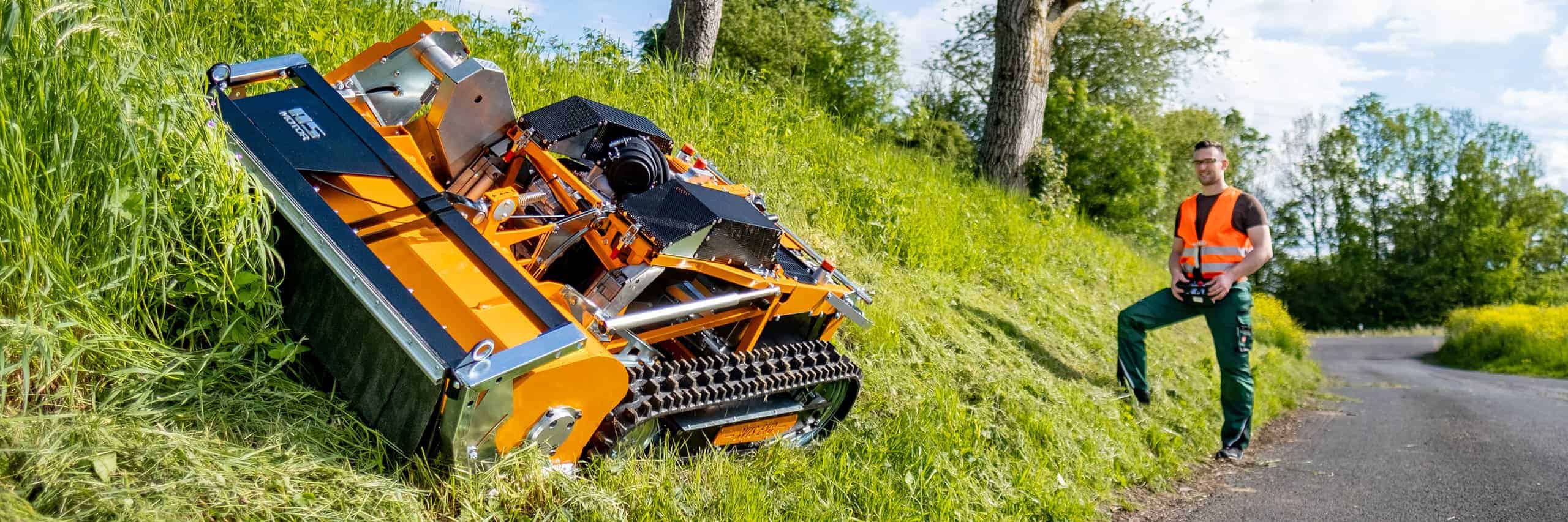 Man using an AS-Motor remote controlled flail mower, AS 1000 Ovis EVO, cutting high grass on a steep slope