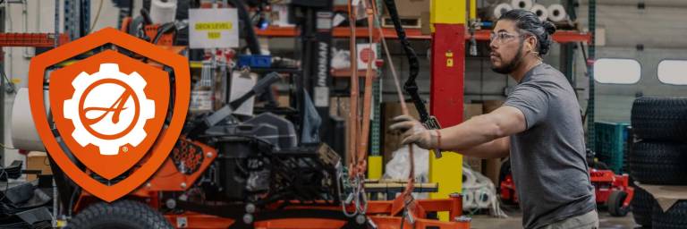 Ariens Warranty feature. Ariens worker assembles an Ariens Zero-Turn stand-on mower in the factory