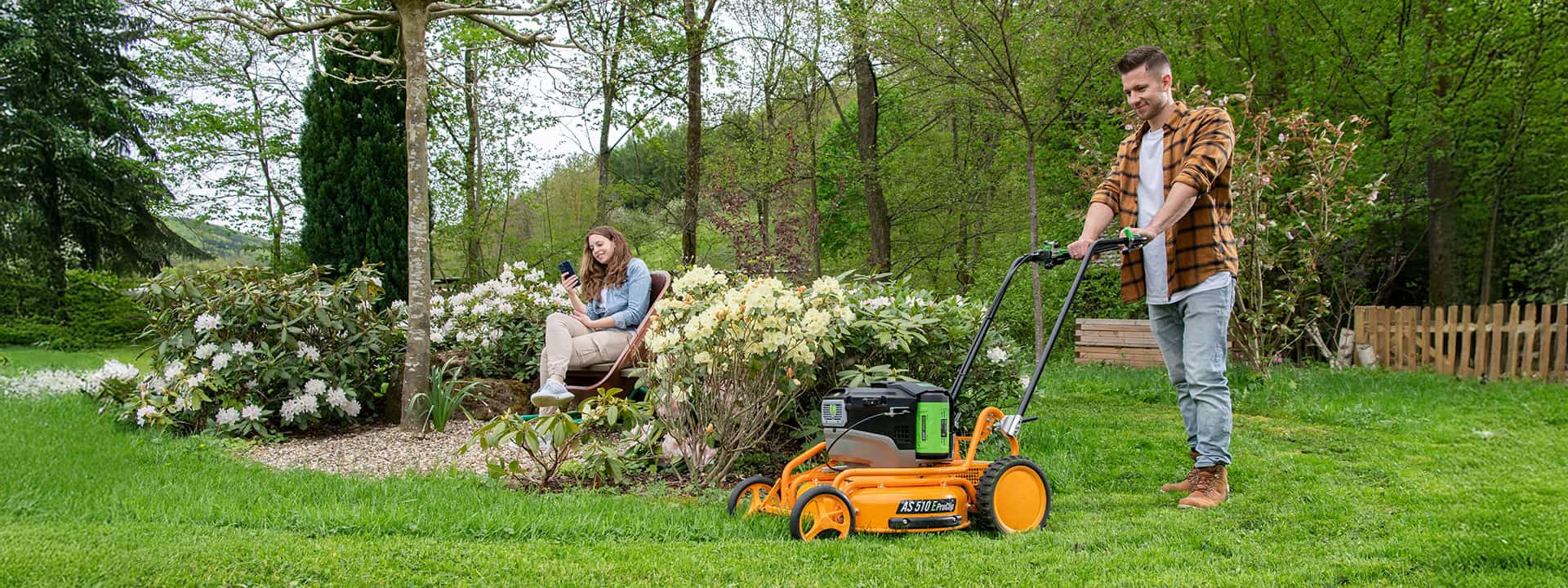 Man using an AS-Motor professional mulching push mower, AS 510 E-Pro-Clip, mowing high gras on steep slopes