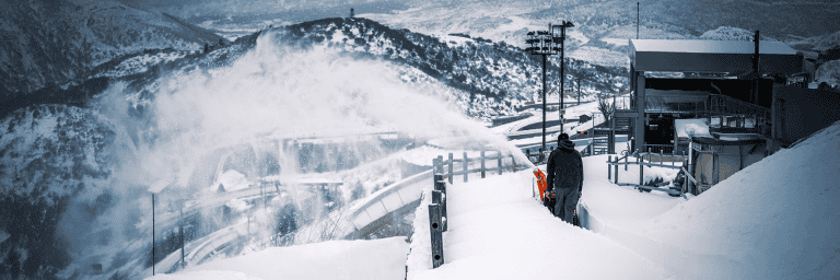 Snow blower clearing snow in Scandinavian winte