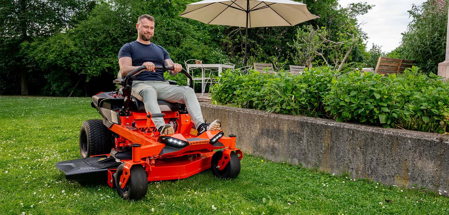 Ariens Zero-Turn Mower model IKON, showcasing efficient mowing with zero-turn features. Happy young man is mowing the lawn with an Ariens Zero-Turn mower